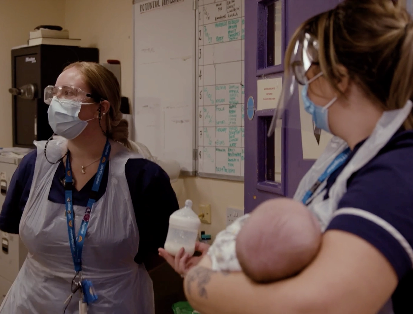 NHS England - 2 nurses with a baby